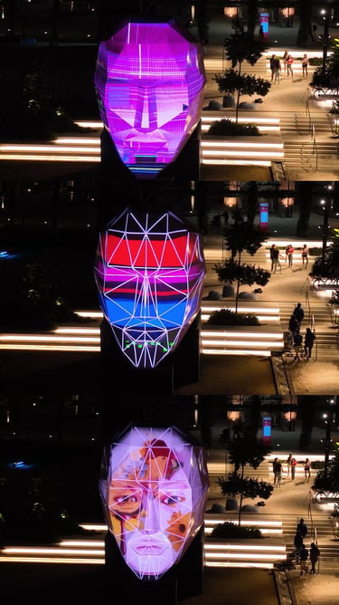 Three views of an illuminated head sculpture displaying different geometric and portrait patterns.