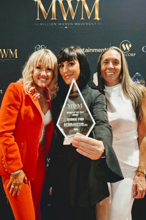 Georgie Pinn holding her Woman of the Year Award