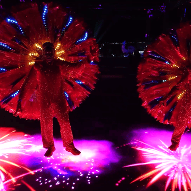 Participant surrounded by red and blue circular light patterns on an interactive floor.